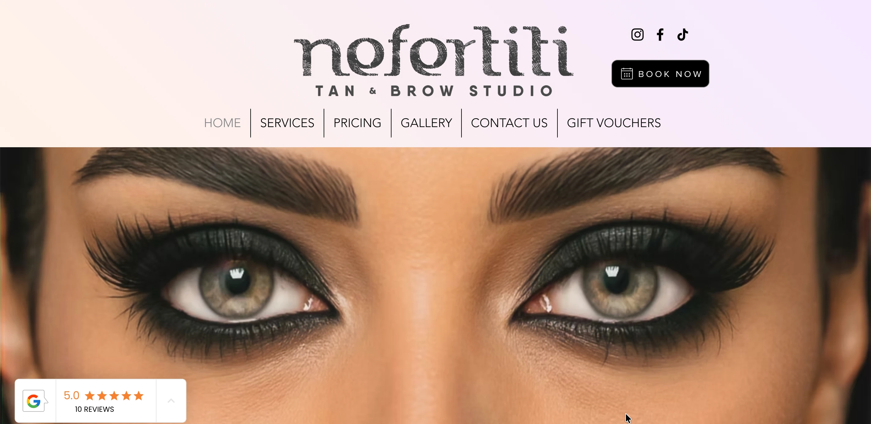 Old Nefertiti Studio homepage banner on Wix, tan and brow salon branding